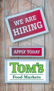 Now Hiring Sign with Tom's Logo
